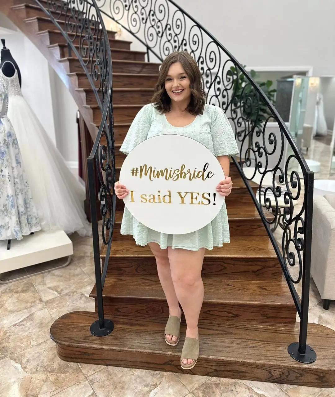 Bride holding 'say yes' sign at Mimi's Bridal