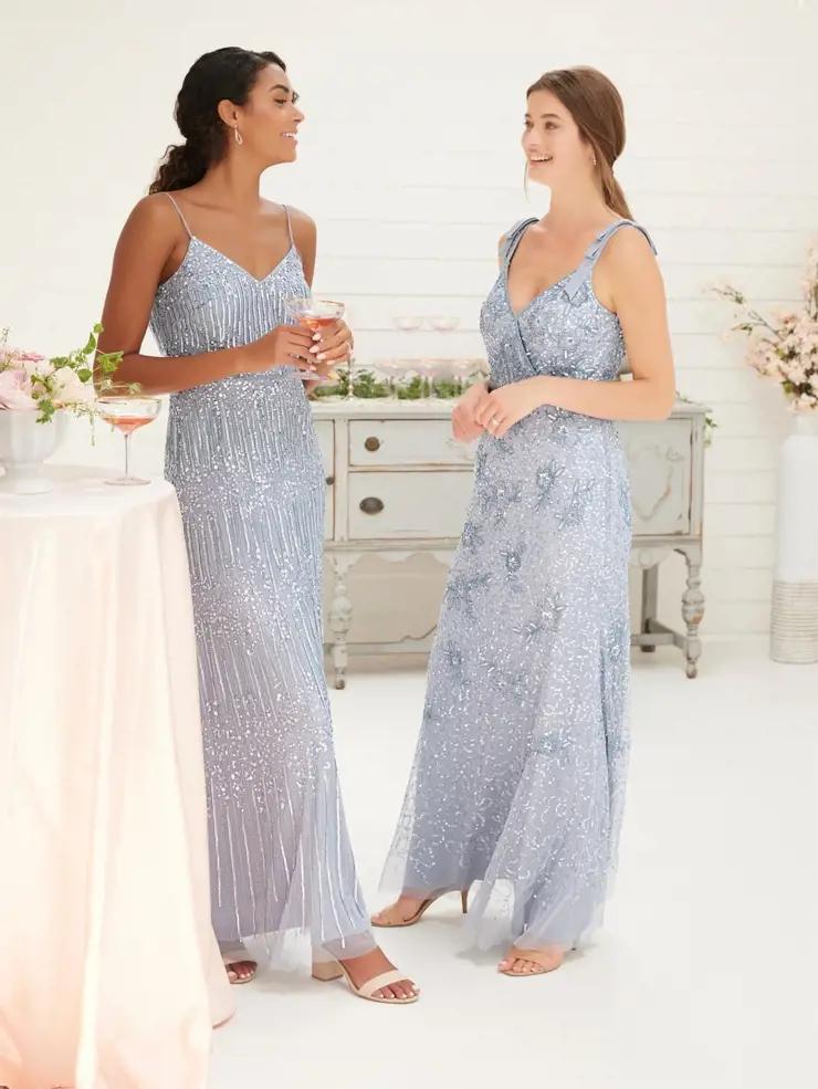 Two models wearing light blue bridesmaid dresses